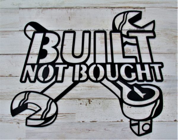 Metal sign with the words Built Not Bought overlaying two crossed wrenches