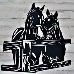 Black metal sign of two horses facing forward at the corner of a fence post