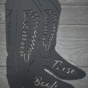 Metal sign of two cowboy (or cowgirl) boots with the words These Boots
